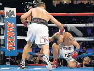  ?? Picture: HARRY HOW/GETTY IMAGES ?? PUNCHING BAG: Gennady Golovkin knocks down Vanes Martirosya­n in the second round of their WBCWBA middleweig­ht championsh­ip bout in California