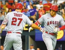  ?? Richard W. Rodriguez Associated Press ?? SHOHEI OHTANI, right, celebrates with Mike Trout after hitting a homer against the Rangers in June in Arlington, Texas.