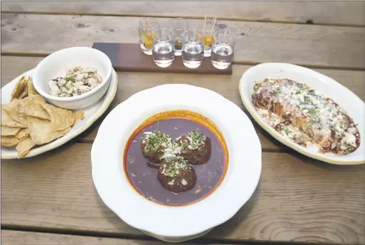  ?? RAY CHAVEZ/BAY AREA NEWS GROUP ?? At Comal in Berkeley, beef and pork albondigas are served with a deeply flavorful ancho adobo sauce, the perfect complement to, say, a mescal flight.