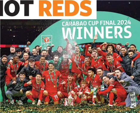  ?? ?? Liverpool players celebrate with the League Cup after beating Chelsea in the final