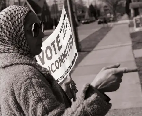  ?? AFP ?? A Democratic voter uncommitte­d to Joe Biden talks to voters outside a polling location in Dearborn, Michigan, last month