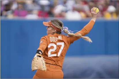  ?? PHOTOS COURTESY OF TEXAS ATHLETICS ?? Ferndale’s Hailey Dolcini held UCLA to just two runs in the Texas Longhorns’ win in the team’s softball College World Series opener Thursday.