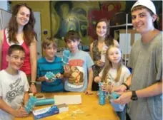  ?? LESLIE FERENC/TORONTO STAR ?? Counsellor­s and visitors create rain noise makers in the music cabin at Camp Winston in Kilworthy, Ont.