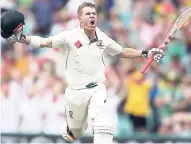  ?? AP ?? Australia’s David Warner raises his arms to celebrate his century before lunch on the opening day of the third Test against Pakistan in Sydney, Australia, on January 3.