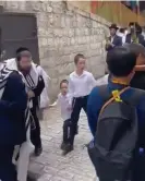  ?? Photograph: Twitter ?? Ultra-Orthodox Jews spitting on the ground beside a procession of foreign Christian worshipper­s.