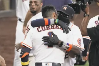  ?? Ashley Landis / Associated Press ?? Houston manager Dusty Baker ( hugging Carlos Correa) just took his record fifth team to the playoffs, guiding a controvers­ial ( and some say unlikable) bunch to Game 7 of the ALCS.