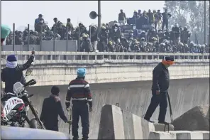  ?? (AP/Rajesh Sachar) ?? Farmers confront police as they are stopped during their march to New Delhi near the Punjab-Haryana border at Shambhu, India, on Tuesday.