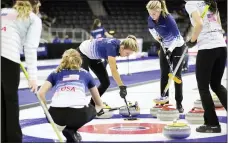  ?? REBECCA S. GRATZ — THE ASSOCIATED PRESS ?? Team Christense­n’s Vicky Persinger, center, sweeps to curl the rock into place in the house as teammates, from Broomall, Sarah Anderson, center left, and Taylor Anderson, center right, stand by while competing against Team Bear at the U.S. Olympic Curling Team Trials at Baxter Arena in Omaha, Neb., on Wednesday.