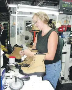  ?? — TC Media file photo ?? Terra Nova Shoes employee Joan Parsons inspects a pair of work boots at a production facility in Harbour Grace in this file photo. Employees at the facility were told Tuesday the factory work will move to Ontario in November.