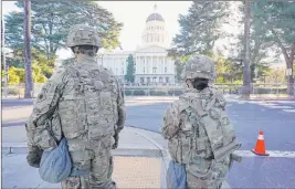  ?? Rich Pedroncell­i The Associated Press ?? A 6-foot-high chain-link fence surrounds the Capitol in Sacramento, Calif., on Wednesday. Gov. Gavin Newsom mobilized the National Guard last week over concerns that protests around the inaugurati­on of President Joe Biden could turn violent.