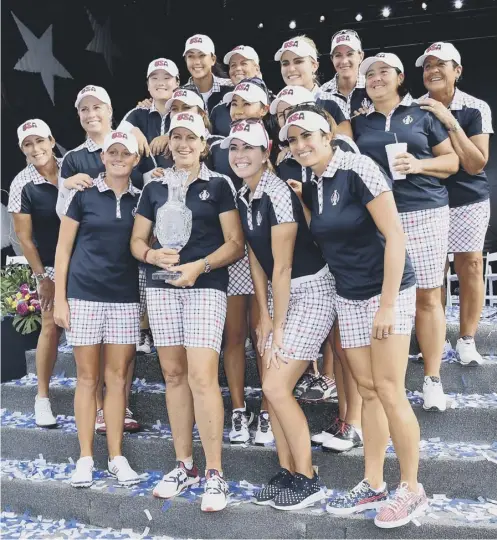  ??  ?? 0 The victorious USA team pose with the Solheim Cup after the closing ceremony at the Des Moines Golf and Country Club in Iowa.