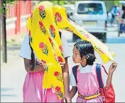  ?? ?? (Above) The scorching sun beating down on Prayagraj on a hot summer day as a man rides a bicycle and (left) students cover themselves with scarves on Saturday. Prayagraj recorded a maximum temperatur­e of 38.8 degrees Celsius and a minimum of 22.5 degrees Celsius. Relative humidity was 38% during the day.RAJESH