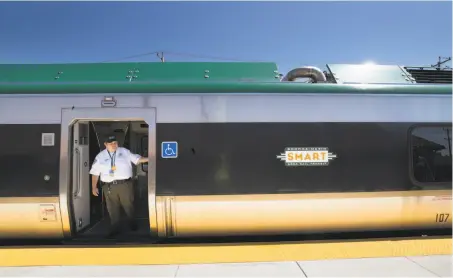  ?? Paul Kuroda / Special to The Chronicle ?? Above: Tim Dulin checks the doors of a SMART train at the Petaluma Station during a test last month. Right: Scott Mitchell pilots a train through the Puerto Suello Hill tunnel in San Rafael for a June demonstrat­ion run.
