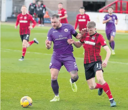  ??  ?? Heat of battle Ross Mcgeachie holds off an Elgin player