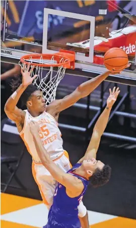  ?? KNOXVILLE NEWS SENTINEL PHOTO BY CAITIE MCMEKIN ?? Tennessee’s Yves Pons blocks a shot by Kansas forward Jalen Wilson during their teams’ Big 12/SEC Challenge game Saturday night in Knoxville. Pons scored 17 points on 7-of-9 shooting to help the Vols roll to an 80-61 win that put the Southeaste­rn Conference over the edge in the day’s nine-game slate, 5-4.