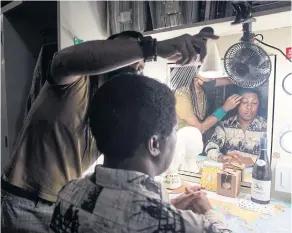  ?? ?? Kenneth Floyd, a member of the Met’s chorus who had to find other work during the coronaviru­s pandemic, has a wig applied backstage before ‘Fire Shut Up in My Bones.’