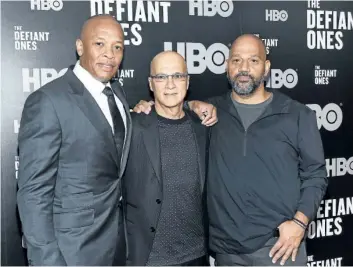  ?? EVAN AGOSTINI/THE ASSOCIATED PRESS ?? Jimmy Iovine, centre, poses with rapper Dr. Dre, left, and producer Allen Hughes at the premiere of HBO’s The Defiant Ones in New York. The four-part documentar­y tracks the lives of Iovine and Dre, and their unlikely partnershi­p.