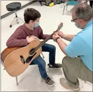  ?? ♦ Contribute­d ?? A Leroy Massey Elementary student learns to play musical instrument­s donated by Remedium.