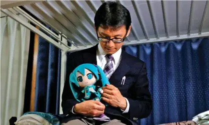  ?? ?? Saved from depression: Akihiko Kondo married a doll of the computer-generated singer Hatsune Miku. Photograph: Reuters/Alamy