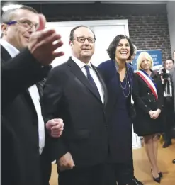  ?? — AFP ?? PARIS: French President Francois Hollande (second left) listens to Vincent Bronze (left), the Director General of French elevators company ETNA France, next to French Labour Minister Myriam El Khomri(fourth left) and mayor of Taverny Florence Portelli...