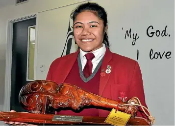  ?? MATTHEW TSO/STUFF ?? Tuimaleali’ifano Fiso, 16, with the Te Manu Koro¯hi Te Ata Po¯ trophy which she won at the Nga¯ Manu Ko¯rero speech competitio­n.