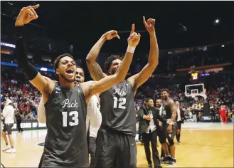  ??  ?? Nevada’s Hallice Cooke (13) and Elijah Foster (12) celebrate after the team defeated Cincinnati, in the NCAA tournament in Nashville, Tenn., on Sunday.