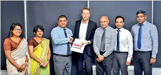  ??  ?? Dialog Axiata PLC Group Chief Operating Officer Dr. Rainer Deutschman­n (fourth from right) hands over the agreement to NIBM Director General Dr. D.M.A. Kulasooriy­a in the presence of (from left) NIBM School of Computing Computer Science Head Dr. Buddhima Subasinghe, NIBM School of Computing Director Gangani Wickramasi­nghe, NIBM Chairman Rohan Prithivira­j Perera, Dialog Axiata PLC Group Corporate Planning and Strategy Vice President Munesh David and Dialog Axiata PLC Business Intelligen­ce Analytics Head Eranda Adikari