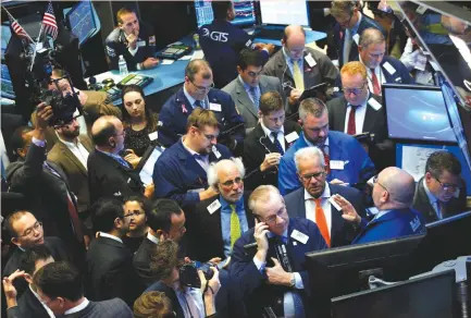  ?? (Brendan McDermid/Reuters) ?? TRADERS WORK on the floor of the New York Stock Exchange last month. US fund managers say that while it is far too soon to tell whether the Republican tax bill will pass, the prospect of increased buybacks is worth taking a bet on companies that would...