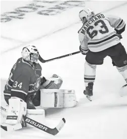  ?? AP ?? Boston’s Brad Marchand scores the winning goal during the overtime period against Montreal on Monday.