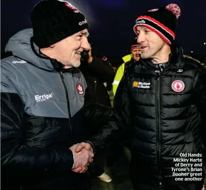  ?? ?? Old Hands: Mickey Harte of Derry and Tyrone’s Brian Dooher greet one another