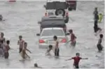  ?? — AFP ?? MANILA: Young residents play on a flooded street in Manila, after tropical depression locally codenamed ‘Maring’, hit the eastern town of Mauban before moving northwest across the main island of Luzon and passing just beside Manila, the government...