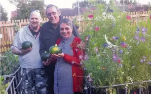 ??  ?? ●●Ann Coffey a the Green Thumbs communal gardens project in Brinningto­n with Tony Seppman (left) and Chris Stonier