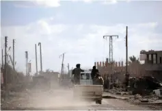  ?? (Reuters) ?? MEMBERS OF the Syrian Democratic Forces clear an area of ISIS fighters.