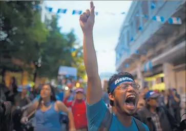  ?? Edwin Bercian EPA/Shuttersto­ck ?? IN GUATEMALA CITY, demonstrat­ors on Friday call for the resignatio­n of President Jimmy Morales.