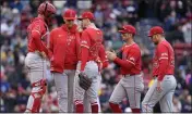  ?? MICHAEL DWYER — THE ASSOCIATED PRESS ?? Angels pitching coach Barry Enright, second from left, has a conference on the mound with starter Griffin Canning.