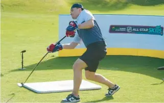  ?? MARTA LAVANDIER/AP ?? Nick Suzuki of the Canadiens hits his first shot with a hockey stick during a golf skills competitio­n Wednesday in Plantation. The event was part of the NHL All Star Weekend.