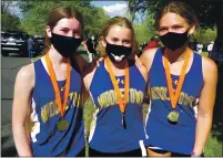  ??  ?? From left, Middletown runners Maya Leonard, Erica Kinsel and Mariah Ketchum all won medals in the girls race for their top-10 finishes. Leonard was third, Kinsel fifth and Ketchum eighth.