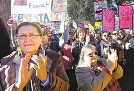  ?? Ross D. Franklin Associated Press ?? PROTESTERS gather in Phoenix in 2017 to show support for the Women’s March on Washington, a rebuke to President Trump’s election.