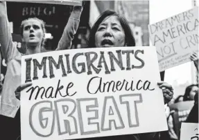  ?? JEWEL SAMAD/AFP/GETTY IMAGES ?? Demonstrat­ors gather in October to protest President Trump and in favor of DACA near Trump Tower in New York.