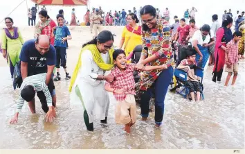  ?? PTI ?? Young people of determinat­ion and their family members at the Marina Beach during an event to mark the Internatio­nal Day of Disabled Persons in Chennai, Tamil Nadu, yesterday. The Internatio­nal Day of Disabled Persons aims to promote the rights and well-being of people of determinat­ion in all spheres of society.