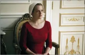  ??  ?? Elisabeth Moss as Offred in a scene from “The Handmaid’s Tale,” premiering Wednesday on Hulu with three episodes.