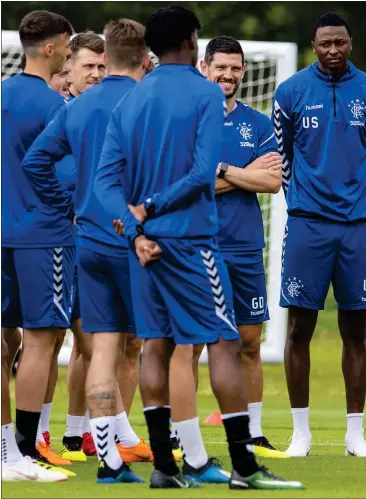  ??  ?? New Rangers manager Steven Gerrard talks his players through his plans at training yesterday ahead of his competitiv­e bow for the club tonight against FK Shkupi