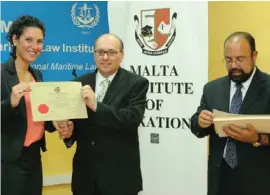  ??  ?? Ms Charmaine Tanti, first in class for the 2012/2013 diploma course, receiving the diploma from the Dean of the Faculty of Law Prof. Kevin Aquilina, in the presence of the president of the Malta Institute of Taxation Dr Renald Micallef