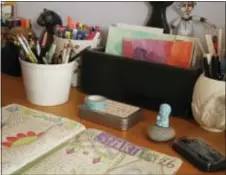  ?? JAMIE RIDLER — JAMIE RIDLER STUDIOS VIA AP ?? This photo provided by Jamie Ridler Studios, in Toronto, Ontario, shows a Fauxbonich­i style journal on a desk with journaling supplies