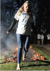 ??  ?? ●●Katie Hetheringt­on takes on the Firewalk challenge for St Ann’s Hospice