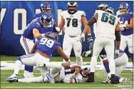  ?? Adam Hunger / Associated Press ?? Philadelph­ia Eagles quarterbac­k Carson Wentz (11) is sacked by New York Giants defensive end Leonard Williams (99) during an NFL game on Sunday in East Rutherford, N. J.