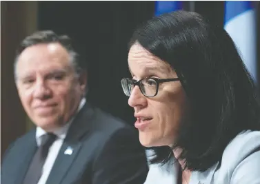  ?? JACQUES BOISSINOT/THE CANADIAN PRESS FILES ?? Sonia Lebel, minister responsibl­e for intergover­nmental affairs, speaks as Premier François Legault looks on. “Legault seems to be trying to softly and de facto separate Quebec from Canada, bit by bit,” Tom Mulcair writes.