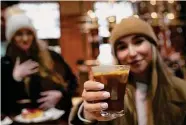  ?? Antonio Calanni/Associated Press ?? Kaya Cupial of Warsaw, Poland, shows an Oleato Iced Cortado coffee at a Starbucks in Milan.