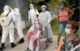  ?? AP ?? Soldiers wearing protective gear prepare to disinfect the Marechal Hermes Urgent Care Unit, as patients wait outside for medical attention, amid the new coronaviru­s pandemic in Rio de Janeiro.