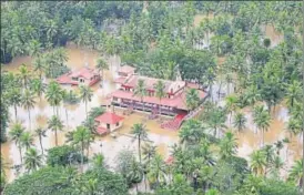  ?? REUTERS ?? An aerial view shows partially submerged houses and a church in a flooded area in Kerala.